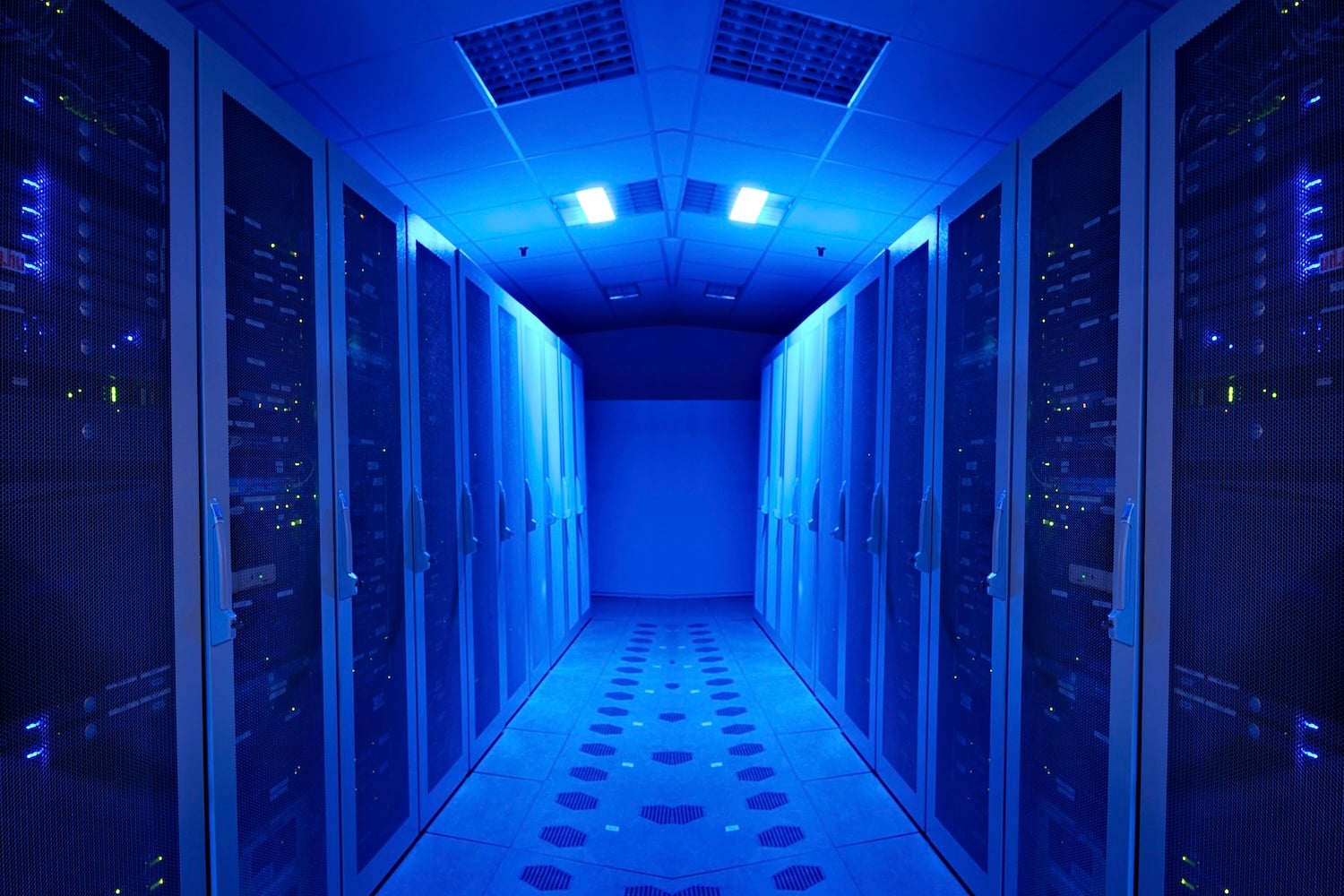 Access passage between data center server cabinets, lit in blue light