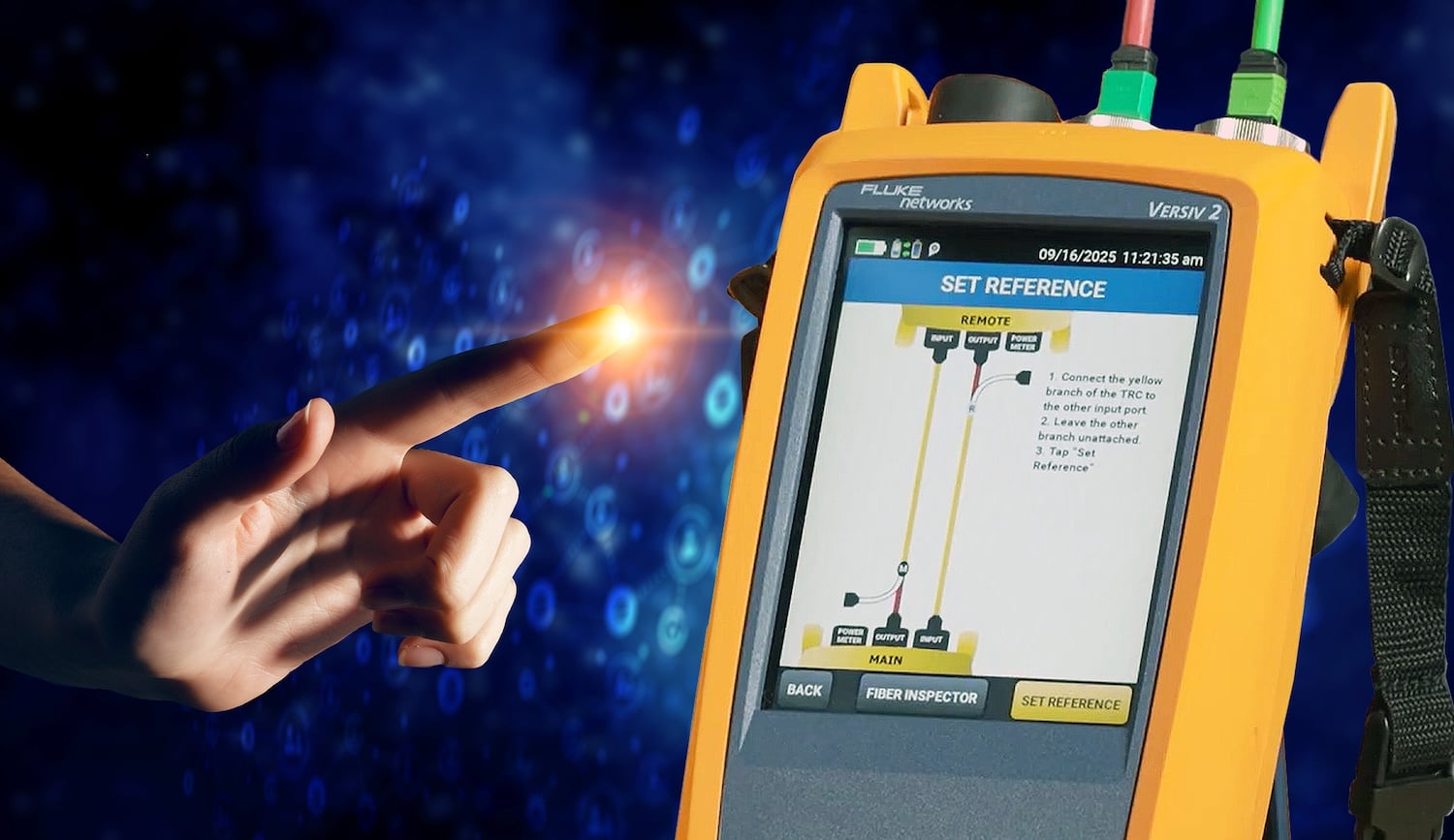 A hand with a glowing fingertip is poised over the Set Reference Wizard screen on the Fluke Networks CertiFiber™ Max