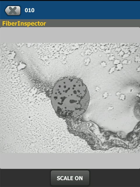 Two images from a fiber optic inspection camera comparing a clean end face with a dirty one